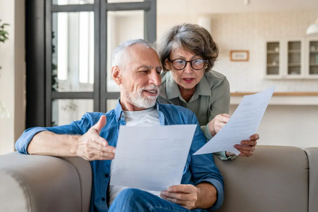 A senior couple looking at papers