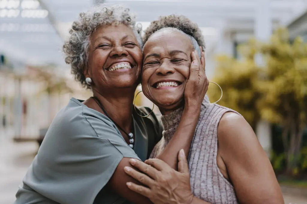 Two senior women hugging