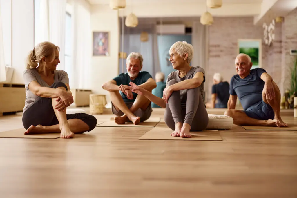 A group of elderly women in yoga class while exploring holistic health and wellness for seniors at Sagewood in Phoenix, AZ.