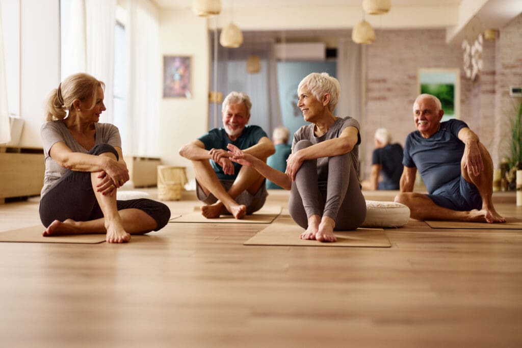 A group of elderly women in yoga class while exploring holistic health and wellness for seniors at Sagewood in Phoenix, AZ.