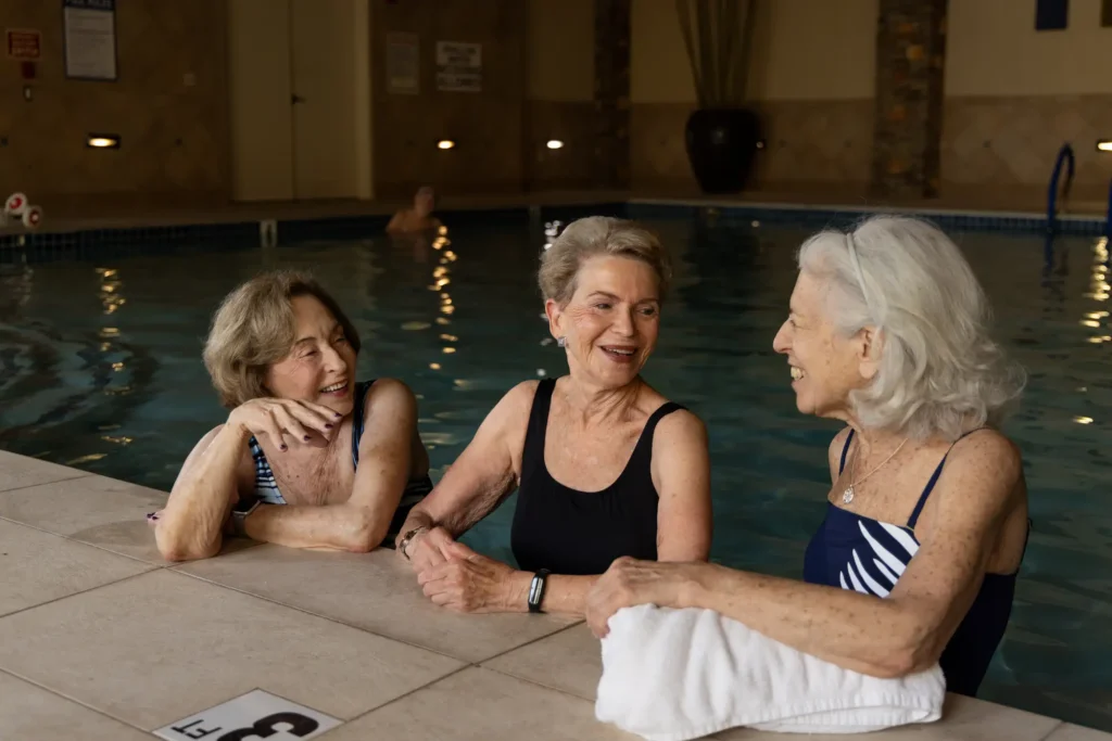 senior women making the most of carefree senior living in the indoor pool at Sagewood in Phoenix, AZ.