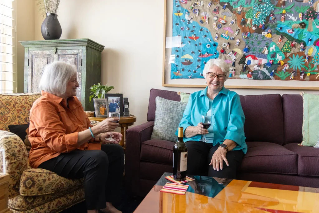 2 elderly women having a drink inside a senior apartment at Sagewood in Phoenix, Arizona.