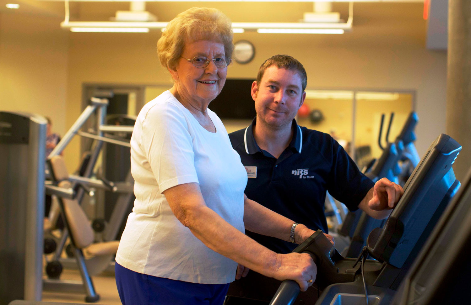 Senior woman exercising with fitness instructor