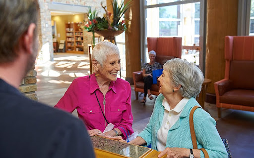two ladies smiling at front desk