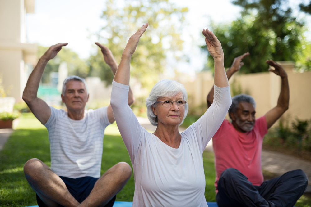 Seniors doing stretching exercises outdoors