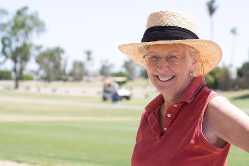 senior lady smiling on golf course