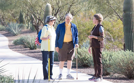 three seniors on walking trail outside